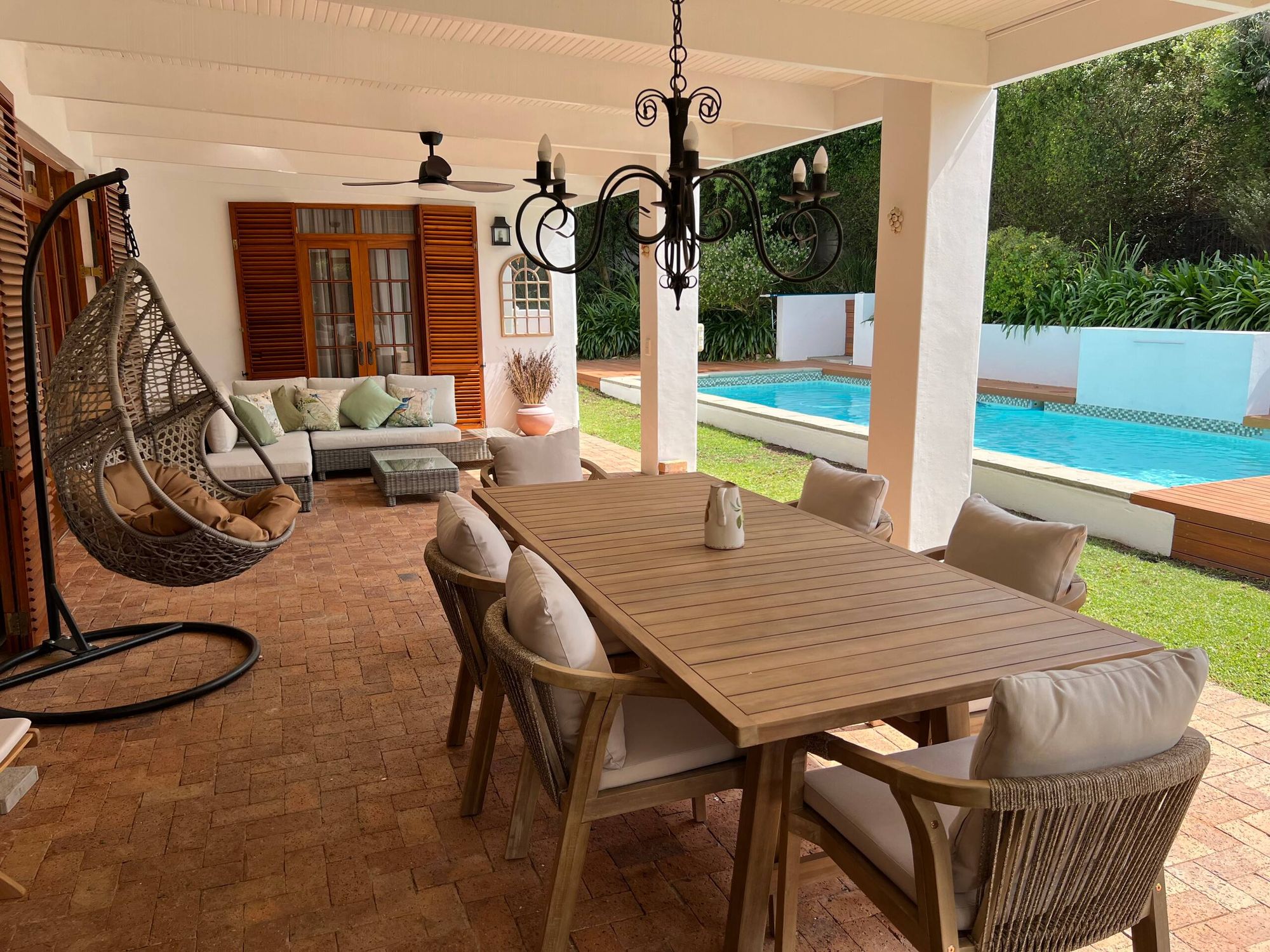 Shaded dining terrace beside the pool