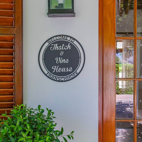 Welcome to Thatch & Vine House sign
